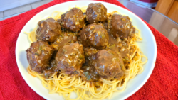 Meatballs smothered in gravy over spaghetti