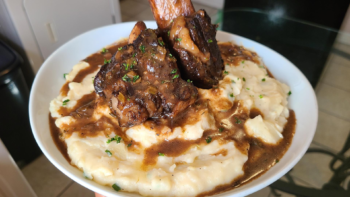 Smothered beef short ribs over garlic butter mashed potatoes